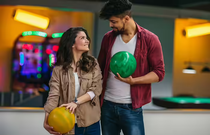 Couple holding bowling balls Couple holding bowling balls