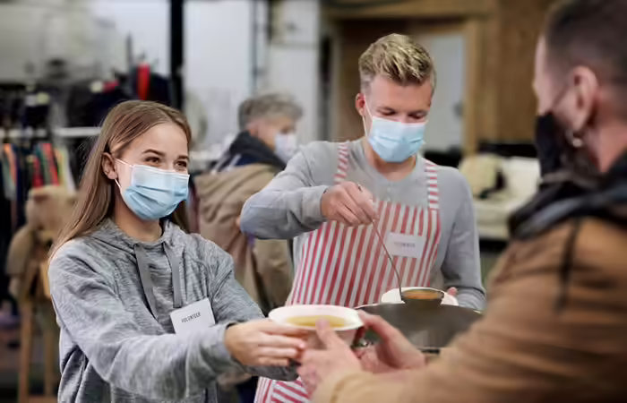 Couple serving food at a local charity Couple serving food at a local charity