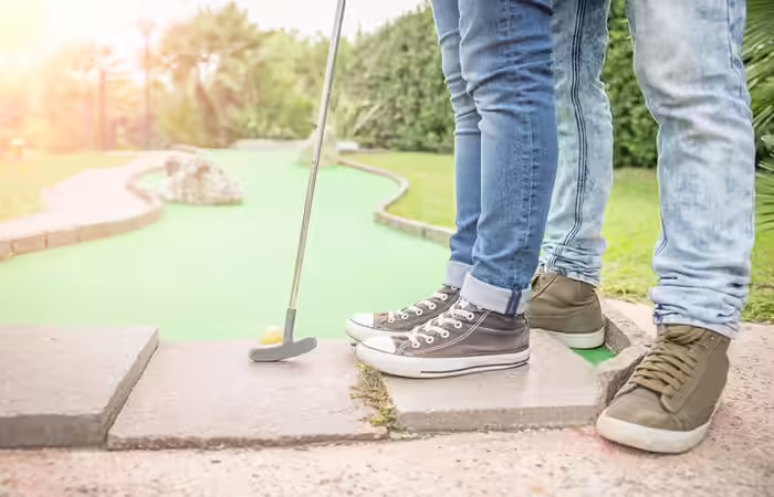 Couple playing mini golf Couple playing mini golf