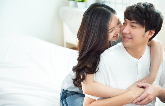 Woman hugging her partner from behind and letting them know they are there for them