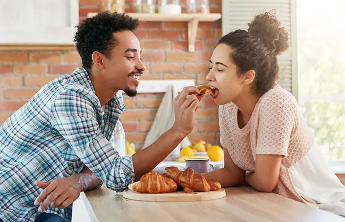 A couple sharing a fun moment at a table