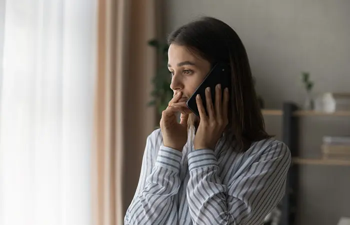 A woman showing signs of anxious attachment triggered by unresponsiveness