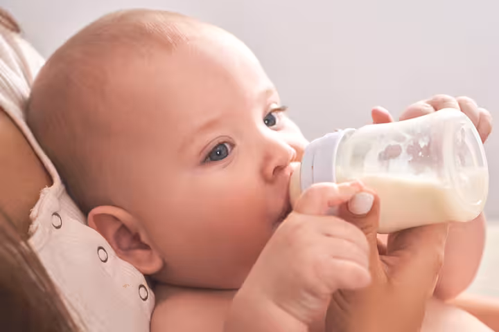 Babies may spit up curdled milk due to formula feeding.