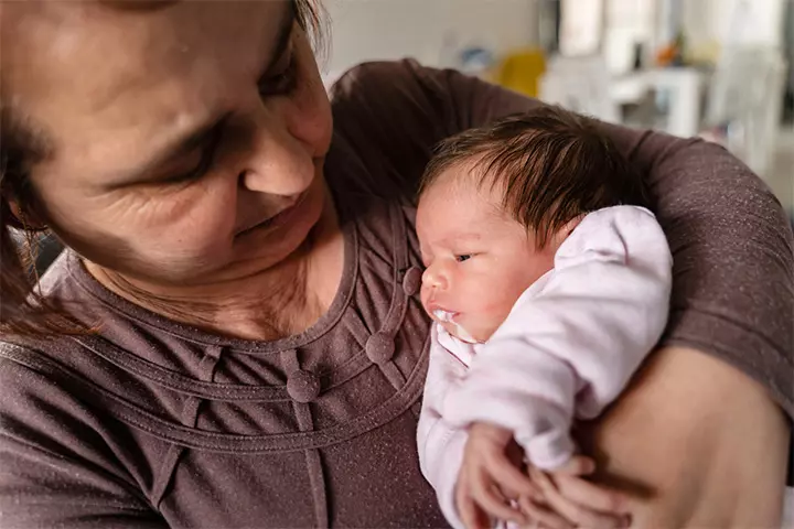 Babies may spit up curdled milk due to overfeeding.