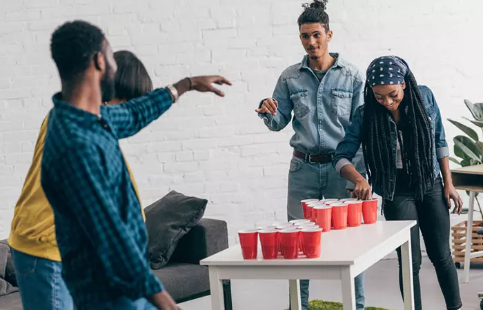 Couples playing beer pong