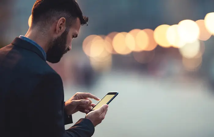 Man in deep contemplation over texting his ex