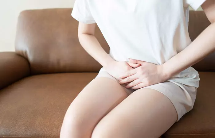 Woman experiencing discomfort in her crotch area due to herpes