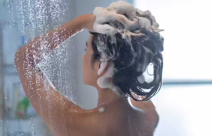 Woman using a clarifying shampoo one day before coloring her hair