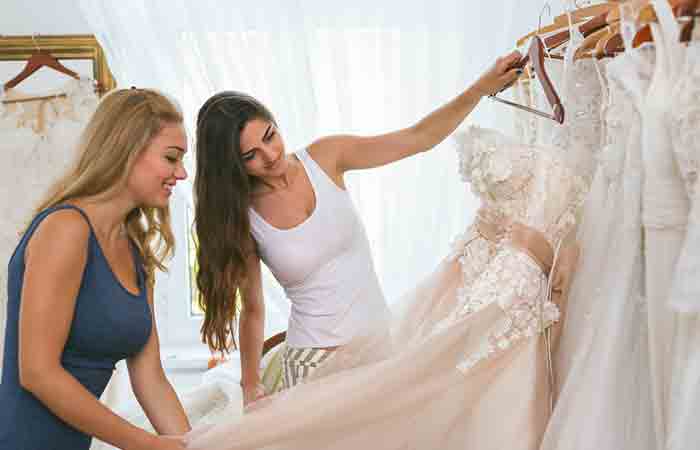 Maid of honor helping with the wedding dress shopping