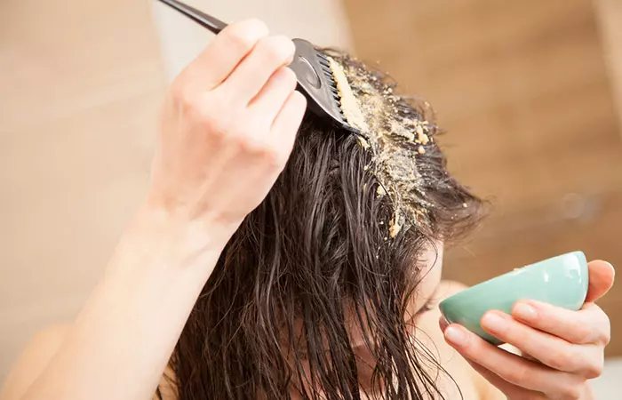 Woman applying rhassoul clay mask