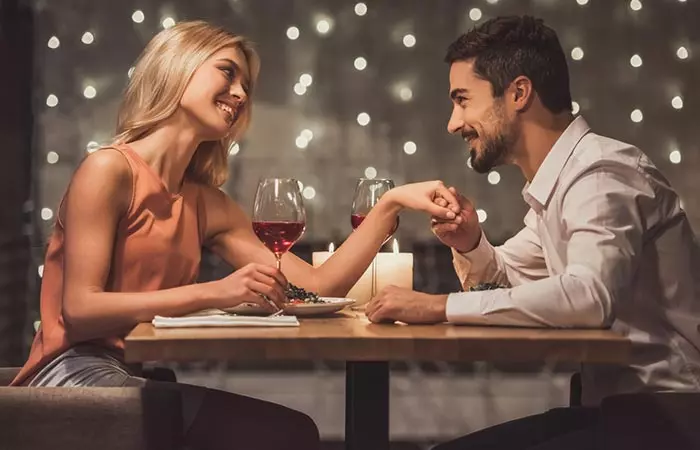 A man holding his partner's hand and showing affection to her