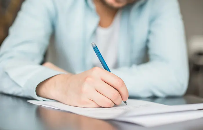 Man writing at the desk