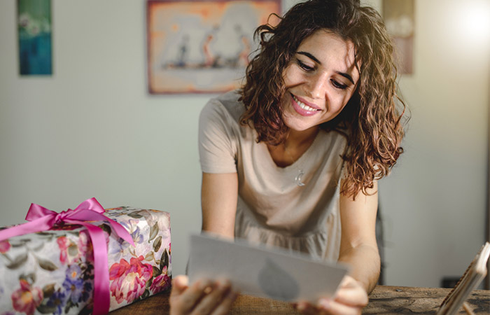 Single woman getting wedding invitation card