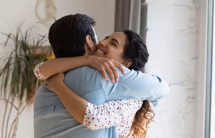 Two people hugging each other tightly.