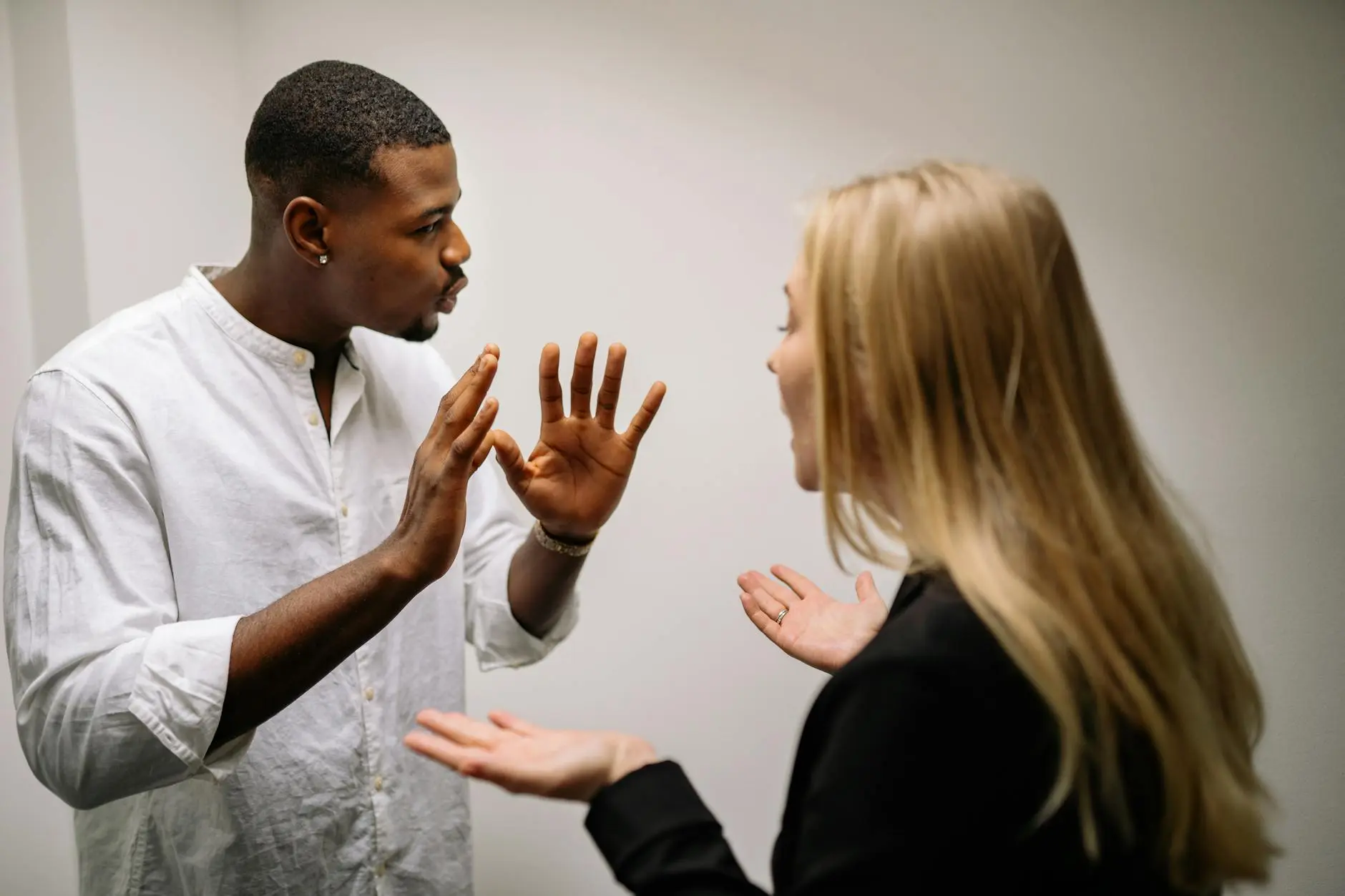 Mirrored movements, helpful gestures and focused attention can signal romantic interest.